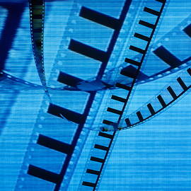 Transparent roll of 35mm movie film displayed on tv screen by Sami Sarkis Photography