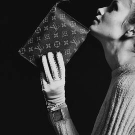 Twiggy Holding Louis Vuitton Envelope Bag by Bert Stern