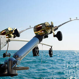 Two Fishing Poles on Back of Boat by Paul Velgos