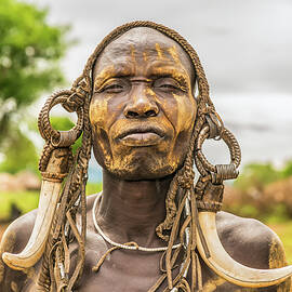 Warrior from the african tribe Mursi, Ethiopia by Miroslav Liska