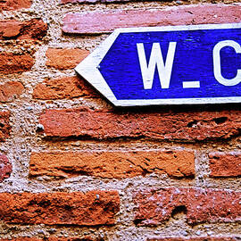 Water closet sign on a brick red wall by Sami Sarkis Photography