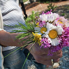Woman holding a bunch of colorful flowers by Sami Sarkis Photography