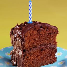 A Slice Of Devil's Food Cake chocolate Layer Cake, Usa With A Birthday Candle by Foodfolio