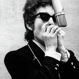 Bob Dylan Playing Harmonica And Guitar by Bettmann