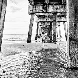 Florida, South Florida, Woman Running Under The Juno Beach Pier by Laura Diez