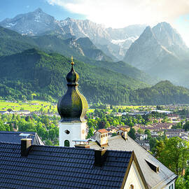 Germany, Bavaria, Bayern, Upper Bavaria, Garmisch-partenkirchen, View Over Partenkirchen With Wallfahrtskirche Sankt Anton Church In The Foreground. by Francesco Carovillano
