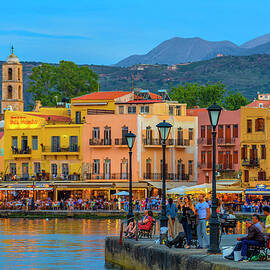 Greece, Crete Island, Crete, Chania, Mediterranean Sea, Aegean Sea, Greek Islands, View Of The Old Venetian Port Of Chania Town At Sunset With The Promenade On Seaside by Giorgio Filippini