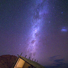Milky way over a small chalet of a desert lodge near Sossusvlei in Namibia by Miroslav Liska