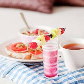 A Breakfast Tray With A Cup Of Tea And A Raspberry Smoothie by Hallström, Lars