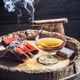 A Glass Of Cognac And Cigars On An Old Wooden Barrel by Shaiith