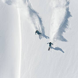 Aerial View Of Two Skiers Skiing by Creativaimage