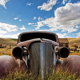 An Old Abandoned Car Rusts Away In The by Rachid Dahnoun