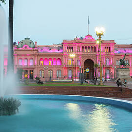 Argentina, Buenos Aires, Plaza De Mayo, Fountain And Casa Rosada Illuminated At Dusk by Jordan Banks