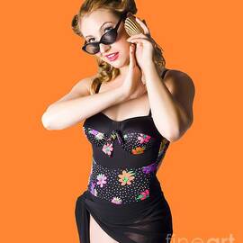 Beautiful 1950s pinup woman listening to sea shell by Jorgo Photography