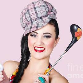 Beautiful female golfer holding golf ball and club by Jorgo Photography