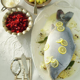 Blue Carp With Lemon Slices And Horseradish Sauce On Plate, Bowls Of Beetroot And Potatoes by Jalag / Götz Wrage