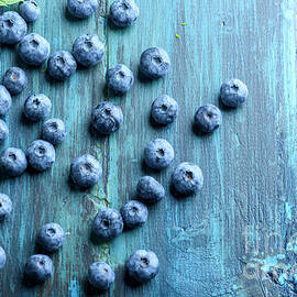 Blueberries ion blue wooden table by Jelena Jovanovic