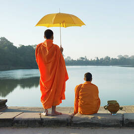 Buddhist Monks Standing In Front Of by Martin Puddy