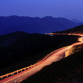 Car Light Trail In Mountain Highway by Samyaoo