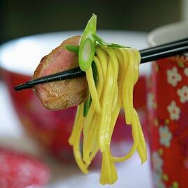 Chinese Noodle Salad With Duck Breast On Chopsticks by Heinze, Winfried