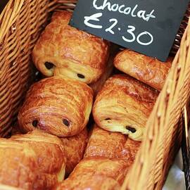 Chocolate Croissants In A Basket With A Price Tag by Langan, Neil