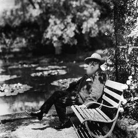 Claude Monet Sitting On Park Bench by Hulton Archive