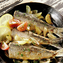 Close-up Of Herrings With Onions, Tomatoes And Slices Of Lemon In Pan by Jalag / Uwe Bender
