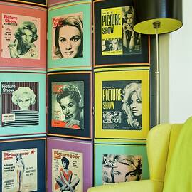 Collection Of Fifties Portraits Of Women On Wall Behind Retro Standard Lamp And Yellow Armchair by Pics On-line / June Tuesday