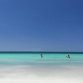 Couple Playing Together In The Water At by Robert Lang Photography