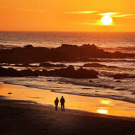 Couple Watch The Sunset At Carmel Beach by Pgiam