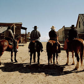 Cowboys Riding Horses Through Town by Matthias Clamer