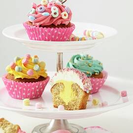Cupcakes With Different Decorations On Tiered Stand by Fröhlich, Heidi