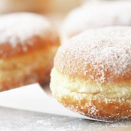 Doughnuts With Icing Sugar close-up by Till Melchior