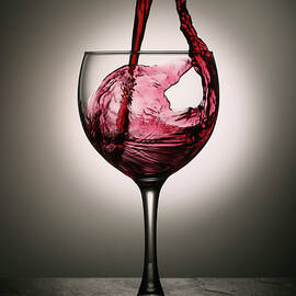 Dramatic Red Wine Splash Into Wine Glass by Donald gruener