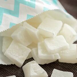 Dried Diced Coconut Falling From A Paper Bag by Sandra Krimshandl-tauscher