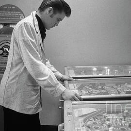 Elvis Presley playing pinball 1956 by The Harrington Collection