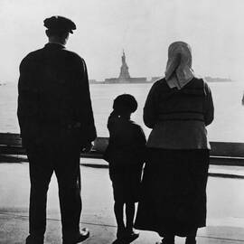 Family Views Statue Of Liberty From by Fpg