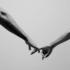 Female And Male Connecting By Fingers by Jonathan Knowles