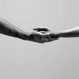 Female And Male Hands by Jonathan Knowles