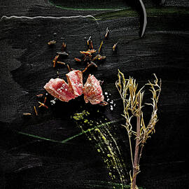 Food Art: Beef With Black Rice, Comfrey And Pesto On A Black Surface by Manfred Rave