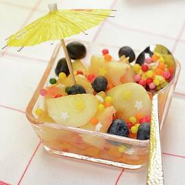 Fruit Salad With White Peaches, Blueberries And A Cocktail Umbrella by Alain Caste