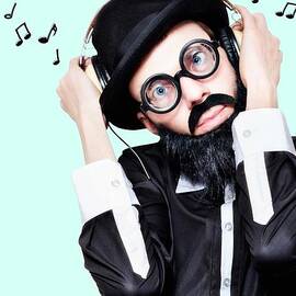 Funny Man Wearing Headphone On Blue Background by Jorgo Photography