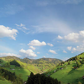 Green Hilly Landscape Below Blue Sky With Clouds by Tre Torri
