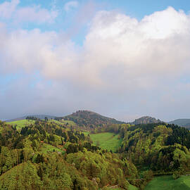 Green Mountain Landscape Below Blue Sky With Clouds by Tre Torri