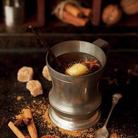 Hot Buttered Rum In A Pewter Mug With Vanilla, Cinnamon, Star Anise And Ground Spices by Jane Saunders