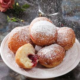 Icing Sugar Being Sifted Over A Plate Of Jam Doughnuts by Boguslaw Bialy