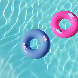 Inflatable Rings In Pool by Peter Cade