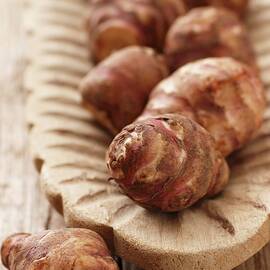 Jerusalem Artichokes In A Wooden Bowl by Gross, Petr