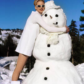 Kristen McMenamy Wearing White By A Snowman by Arthur Elgort