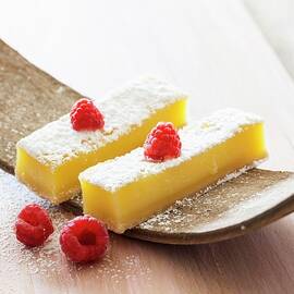 Lemon Bars With Powdered Sugar And Raspberries by Lerner, Danny